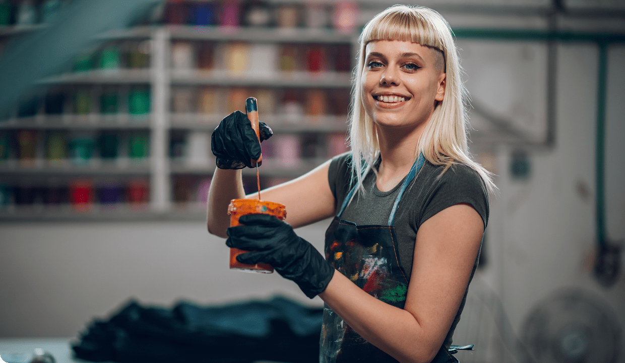 Smiling woman with paintbrush