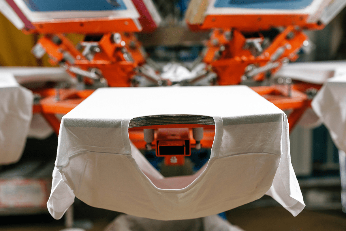 Close-up of a white robotic arm in a manufacturing facility.